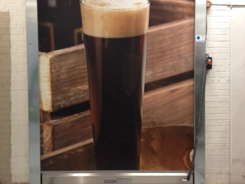 Print on curtain showing well-poured beer